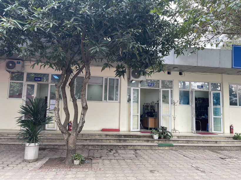 A building with a tree in frontDescription automatically generated with low confidence