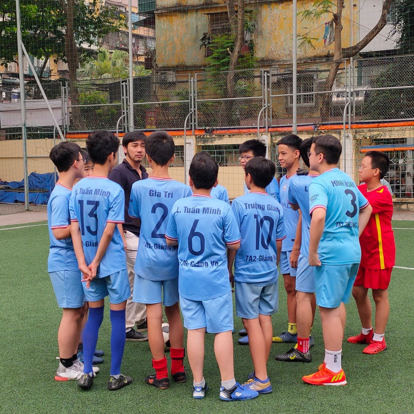 A group of boys in blue uniformsDescription automatically generated with low confidence