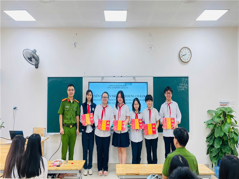 A group of people standing in a classroomDescription automatically generated