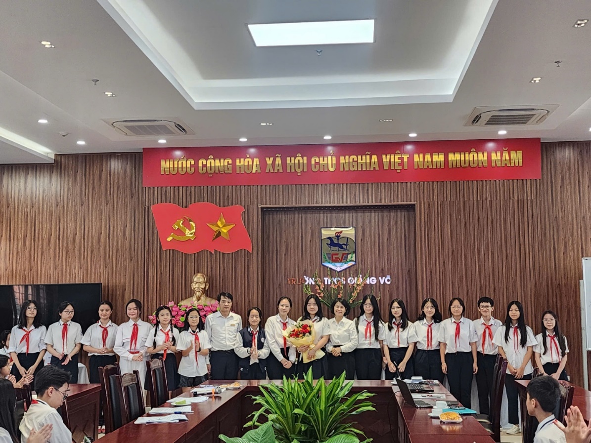 A group of people standing in a roomDescription automatically generated