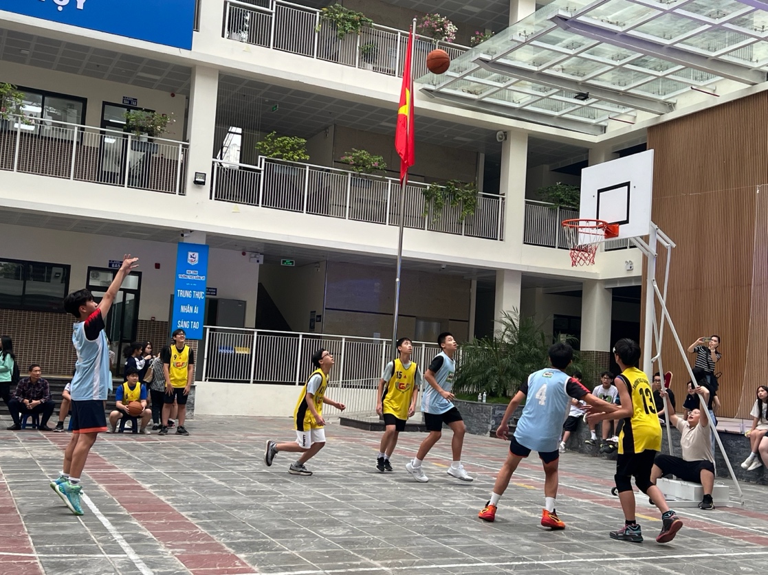 A group of people playing basketballDescription automatically generated