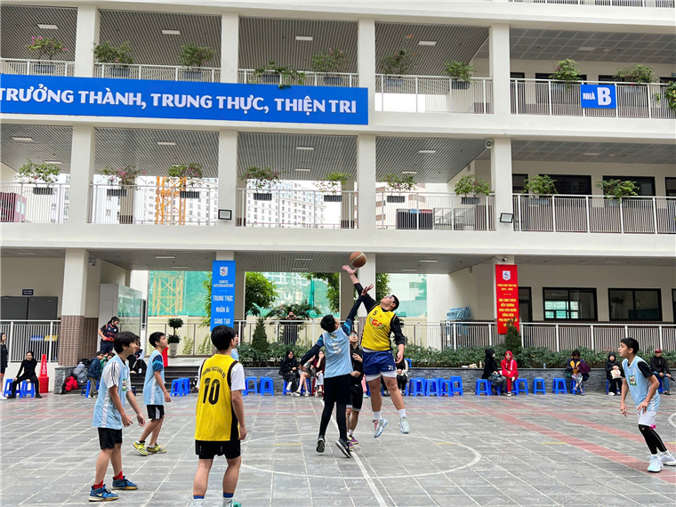 A group of people playing basketballDescription automatically generated