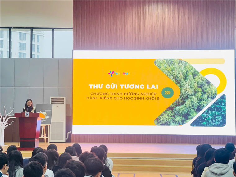 A person standing in front of a large screenDescription automatically generated