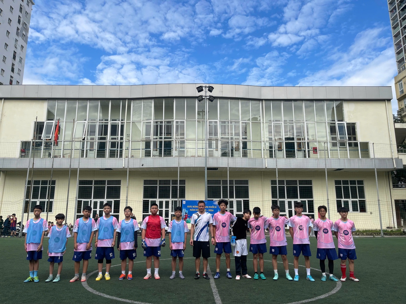 A group of people in a sports uniformDescription automatically generated