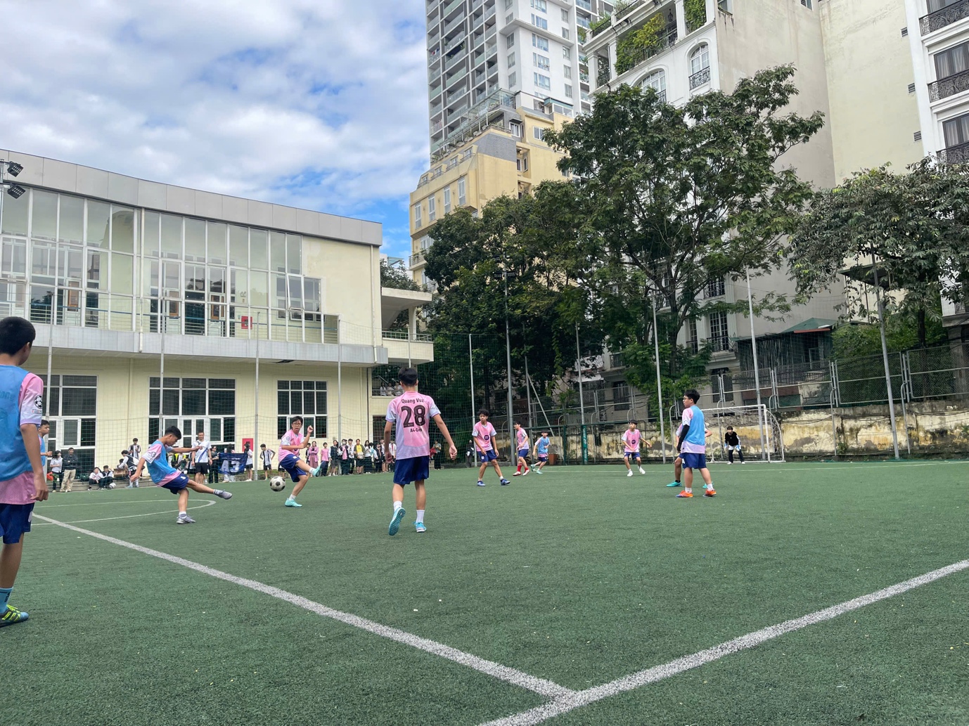 A group of people playing footballDescription automatically generated