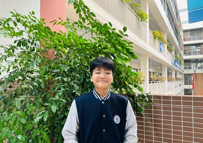 A child standing in front of a buildingDescription automatically generated
